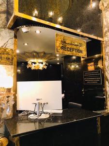 a room with a counter with a whiteboard and a sign at Zee Hotel in Dubai