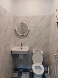 a bathroom with a toilet and a sink and a mirror at Baan seefa homestay kohyaoyai in Ko Yao Yai