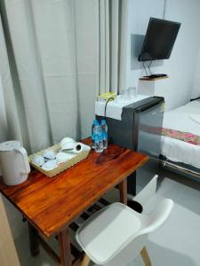 a room with a wooden table and a television at Baan seefa homestay kohyaoyai in Ko Yao Yai