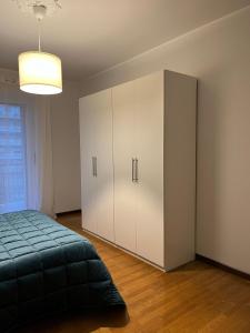a bedroom with a bed and a large cabinet at A Casa di Simo in Turin +17 photos