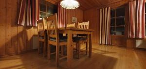 a dining room with a wooden table and chairs at Sauna | Wi-Fi | Terrace | Wood stove | Cable TV in Lofsdalen +6 photos