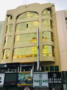 a large building with a lot of windows at Zee Hotel in Dubai
