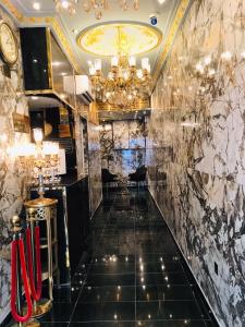 a lobby of a hotel with a chandelier at Zee Hotel in Dubai