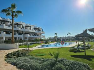 a large apartment complex with a swimming pool and a resort at El Sueño in San Juan de los Terreros