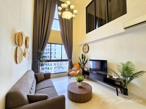 a living room with a couch and a table at Loft Suite Central City 2BR JB CIQ 7Pax in Johor Bahru