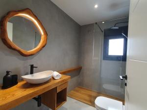 a bathroom with a sink and a mirror at Apartamentos Islas Pantorgas in Tapia de Casariego +14 photos
