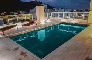 a pool on the roof of a building at night at Augusto Apart 4 in Salta