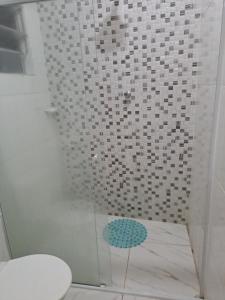 a shower with a blue umbrella in a bathroom at Casa Grande na zona sul in Sao Paulo