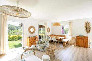a living room with a table and a dining room at Tamariu - Beautiful Villa with Pool in Palafrugell