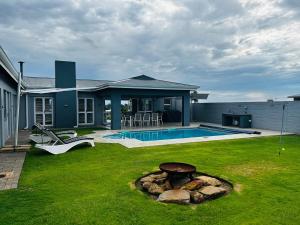 a house with a yard with a swimming pool at Harbour Town 12 Sleeper in Vaal Marina