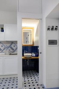 a bathroom with a sink and a mirror at Le Due Sorelle in Vietri sul Mare