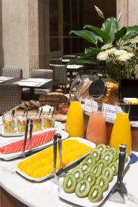 a table with different types of food on it at NH Córdoba Urbano in Córdoba