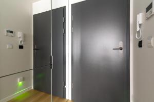 a glass door in a room with a refrigerator at Apartamenty Freedom in Poznań