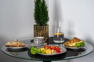 a table with plates of food on a table at Apartamenty Freedom in Poznań +7 photos