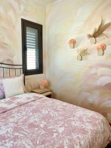 a bedroom with a bed and flowers on the wall at Lovely location, near harbour, restaurants,Mall in Paphos City