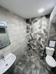 a bathroom with a toilet and a sink at July apartaments in Velingrad