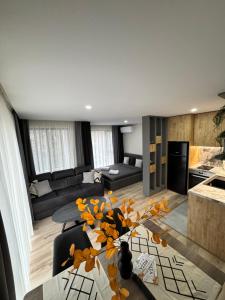 a living room with a couch and a table at July apartaments in Velingrad