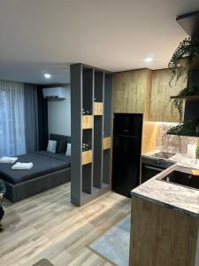 a kitchen and living room with a couch and a counter at July apartaments in Velingrad
