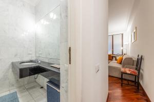 a bathroom with a sink and a mirror at Santa Sofia - Mercalli Cozy Apartment in Milan