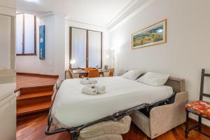 a bedroom with a bed with two teddy bears on it at Santa Sofia - Mercalli Cozy Apartment in Milan