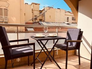 a table and two chairs on a balcony at Monaco border, 2-room Josephine, pool, Bnb Rickeys in Beausoleil