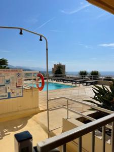 a view of a swimming pool with a red sign at Monaco border, 2-room Josephine, pool, Bnb Rickeys in Beausoleil +8 photos