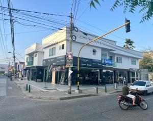 a man on a motorcycle on a city street at Apartamentos VIOLETTA in Cereté