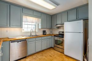 a kitchen with blue cabinets and a white refrigerator at Beachy Keen in Dauphin Island