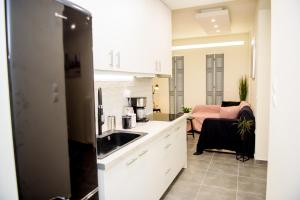 a kitchen with a sink and a counter top at Athenian Hideaway - Spa Tub and Walk to Metro in Athens