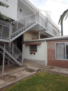 a house with a staircase on the side of it at Casas Ña Zuna depto 6 in Concepción del Uruguay