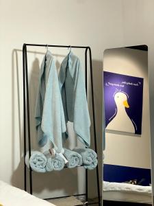 a towel rack with towels and a mirror at 嘿夏天 HeySummer-13pax l 200mJetty l Netflix l Games l Youtube in Mersing +38 photos