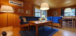 a living room with blue chairs and a table at Sauna | Wi-Fi | Terrace | Wood stove | Cable TV in Lofsdalen