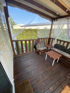 a screened in porch with a couch and a table at Mobilhome de Lucie et Julien in Les Mathes