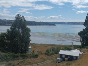 a house on a hill with a view of a lake at Cabañas vista al mar in Coñico