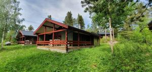 a small house in the middle of a field at Sauna | Wi-Fi | Terrace | Wood stove | Cable TV in Lofsdalen