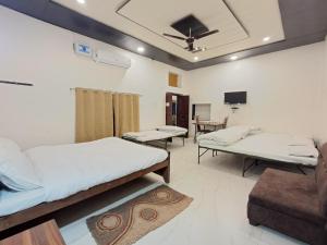 a hospital room with two beds and a tv at LD Guest House, Ayodhya in Ayodhya