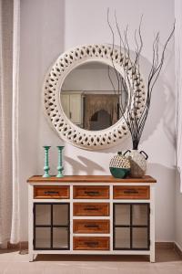 a mirror on top of a dresser in a room at Aroma Kastellia - Althea Homes in Amoopi