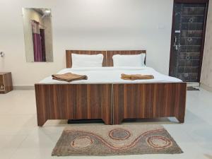 a bed with two towels on it in a bedroom at LD Guest House, Ayodhya in Ayodhya