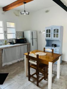 a kitchen with a wooden table and a refrigerator at Villanto apart Solo Adultos in Mina Clavero