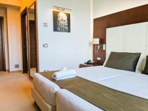 Postel nebo postele na pokoji v ubytování Il Gentiluomo Hotel & SPA