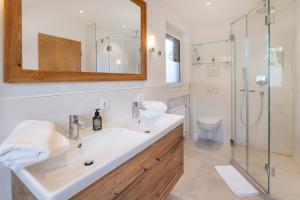 a bathroom with a sink and a shower at Suite Werdenfels in Garmisch-Partenkirchen