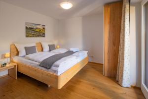 a bedroom with a wooden bed in a room at Suite Werdenfels in Garmisch-Partenkirchen