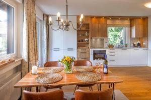 a dining room with a wooden table and chairs at Suite Werdenfels in Garmisch-Partenkirchen