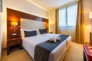 Postel nebo postele na pokoji v ubytování Il Gentiluomo Hotel & SPA