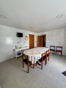 a dining room with a table and chairs and a television at Casa do Rosário - Ribeira Grande in Ribeira Grande +18 photos