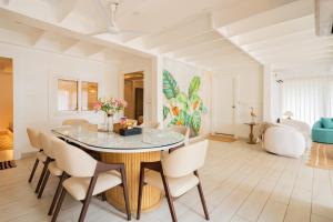 a dining room with a table and chairs at ELIVAAS House of Neptune - 3 BHK Cottage with Terrace & Gazebo on the Beach in Morjim