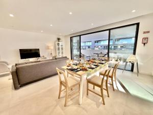 Lagos Prestige With Pool by Homing في لاغوس: غرفة طعام مع طاولة وكراسي وأريكة