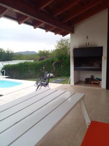 a patio with a fireplace next to a pool at Casa en Lomas del Rey - Mayu Sumaj in San Antonio de Arredondo