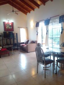 a living room with a couch and a table and chairs at Casa en Lomas del Rey - Mayu Sumaj in San Antonio de Arredondo