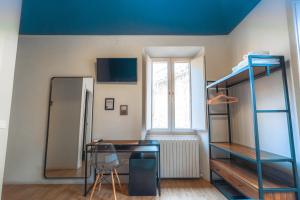 a room with a desk and bunk beds in it at I Mecenati in Macerata